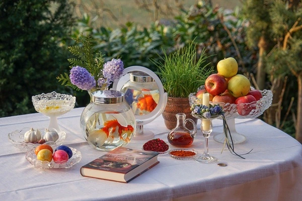 Haft-Seen table with symbolic items like garlic, coins, and apples for Nowruz. Haft-Seen table with symbolic items like garlic, coins, and apples for Nowruz.